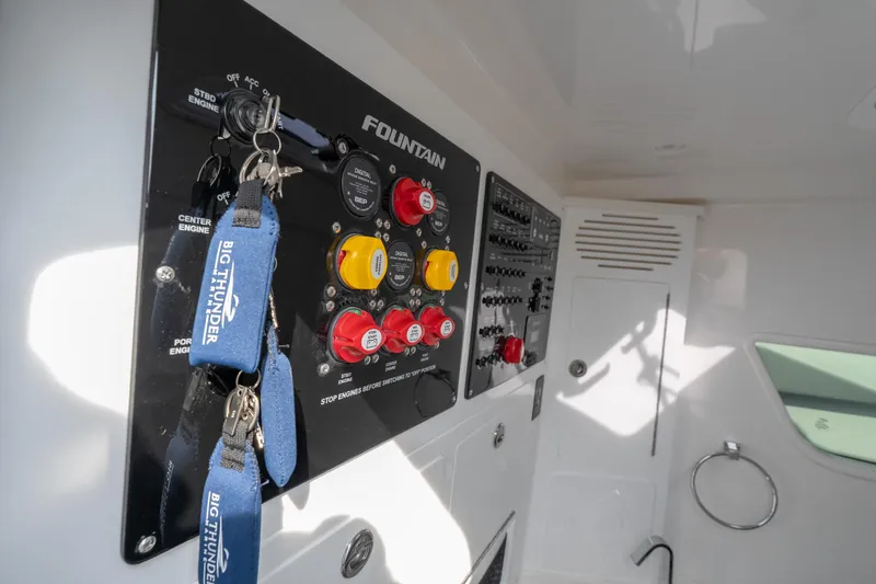 Slide: The Image of Control panel of 2026 Fountain 38 SCX boat with keychains and switches. - 45