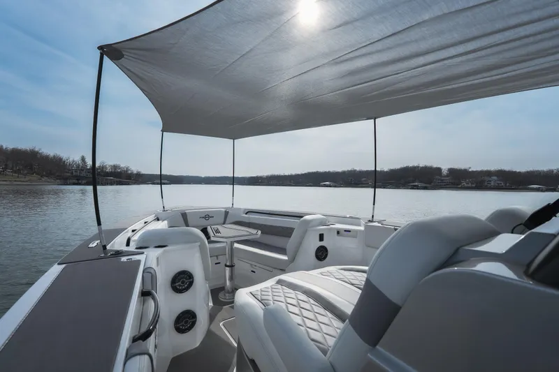 Slide: The Image of 2026 Fountain 38 SCX boat with canopy, luxurious seating, and scenic lake view. - 47