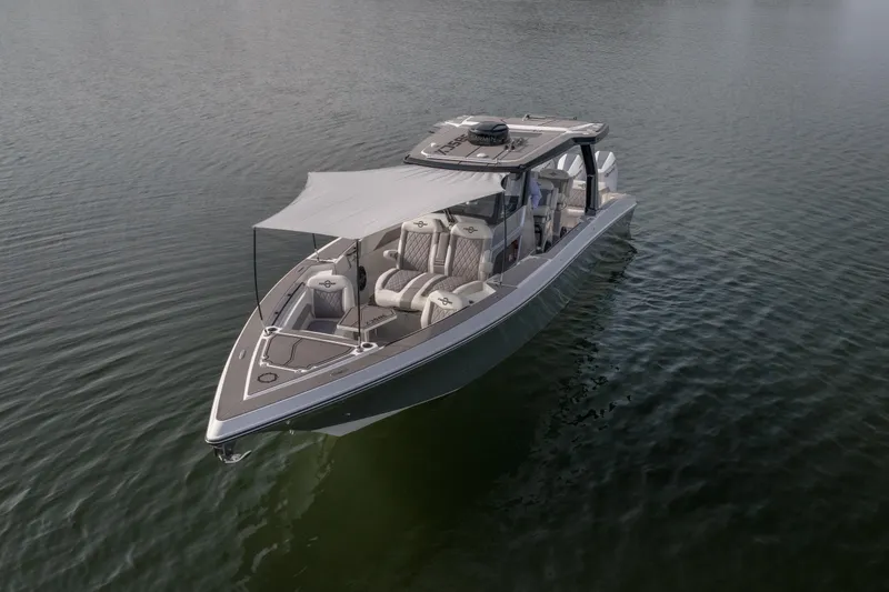 Slide: The Image of 2026 Fountain 38 SCX boat on calm water with canopy and modern design. - 48