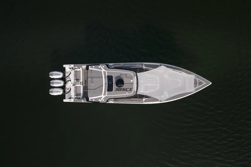 Slide: The Image of Aerial view of 2026 Fountain 38 SCX boat with triple engines on dark water. - 49