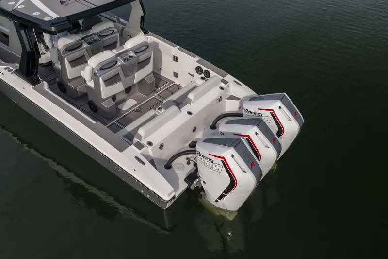 Slide: The Image of 2026 Fountain 38 SCX boat with triple outboard engines on calm water. - 55