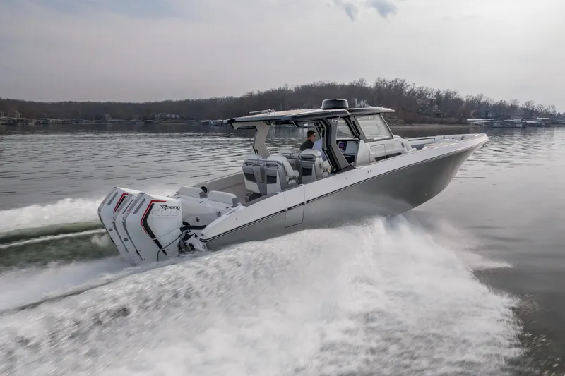 Slide: The Image of 2026 Fountain 38 SCX boat cruising on a calm lake, showcasing powerful engines. - 56