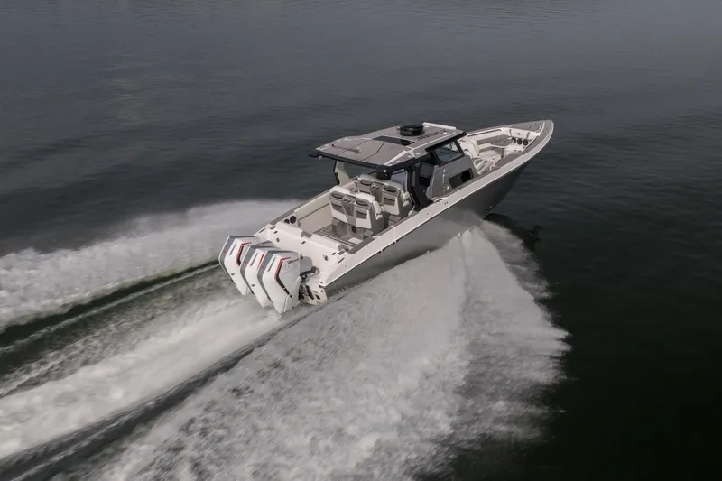 Slide: The Image of 2026 Fountain 38 SCX boat speeding on water, showcasing powerful engines and sleek design. - 57