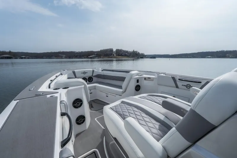 Slide: The Image of 2026 Fountain 38 SCX boat interior with luxurious seating on a calm lake. - 6