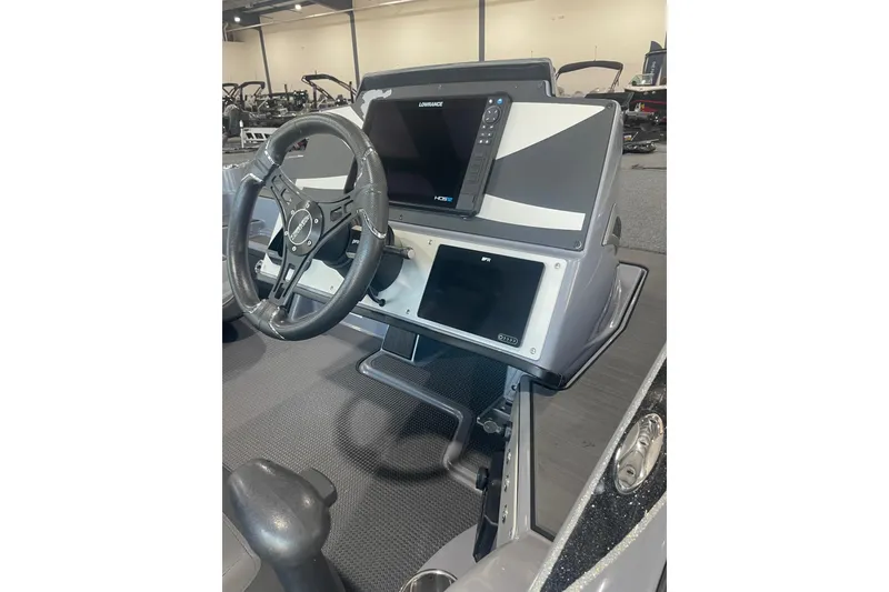 Slide: The Image of 2023 Triton 21 XrT boat dashboard with steering wheel and electronic display. - 10