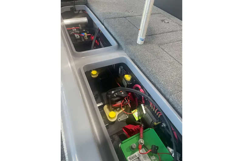 Slide: The Image of 2023 Triton 21 XrT boat battery compartment with wiring and components. - 14