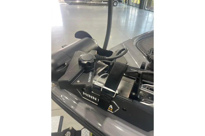 Slide: The Image of 2023 Triton 21 XrT boat with Garmin and Minn Kota equipment in showroom. - 18