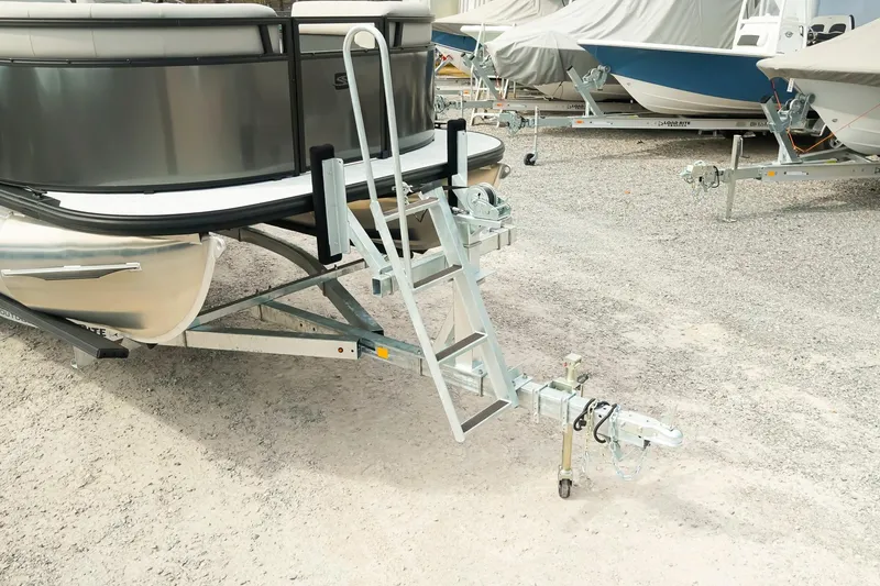 Slide: The Image of 2026 Dockside 20 DQ boat on trailer with ladder, parked on gravel lot. - 29