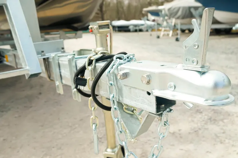 Slide: The Image of Trailer hitch of 2026 Dockside 20 DQ boat, featuring secure chains and locking mechanism. - 30