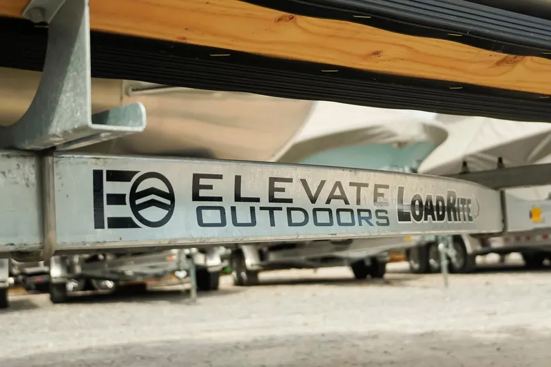 Slide: The Image of Elevate Outdoors LoadRite trailer, Dockside 20 DQ, 2026 model, parked on gravel. - 31