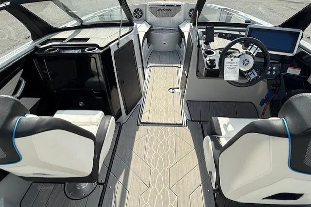 Slide: The Image of 2023 Yamaha Boats 222XE interior with modern dashboard and seating. - 10