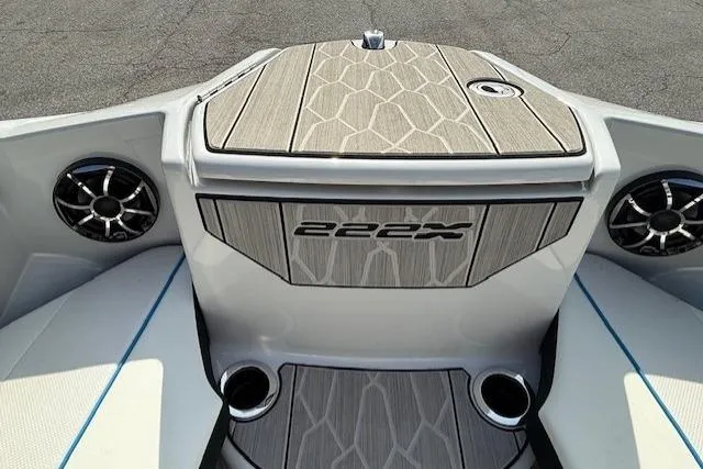 Slide: The Image of 2023 Yamaha Boats 222XE interior with stylish deck and speakers. - 12