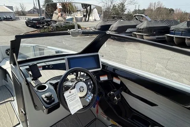 Slide: The Image of 2023 Yamaha Boats 222XE dashboard with steering wheel and touchscreen display. - 22