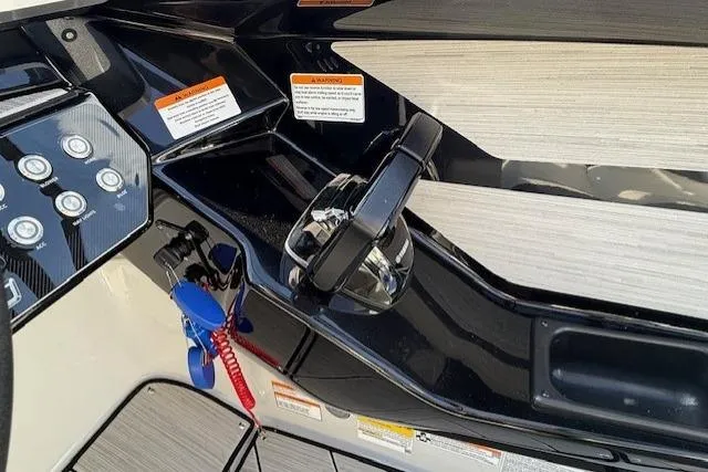 Slide: The Image of Control panel of 2023 Yamaha Boats 222XE with throttle and safety features. - 23