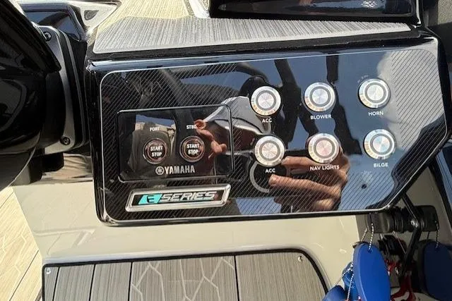 Slide: The Image of Control panel of 2023 Yamaha Boats 222XE with start buttons and accessory switches. - 25