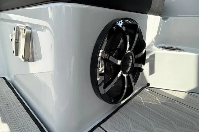 Slide: The Image of 2023 Yamaha Boats 222XE speaker detail on sleek white deck. - 26