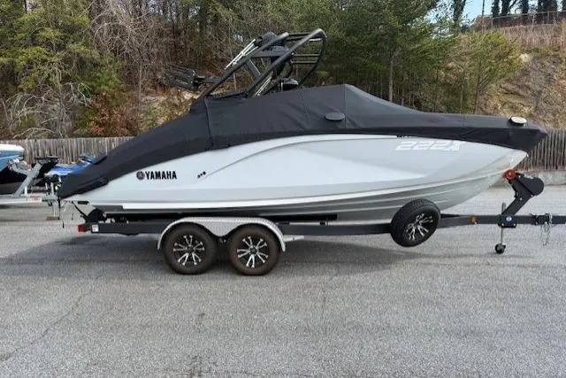 Slide: The Image of 2023 Yamaha Boats 222XE on trailer, covered, parked outdoors. - 5