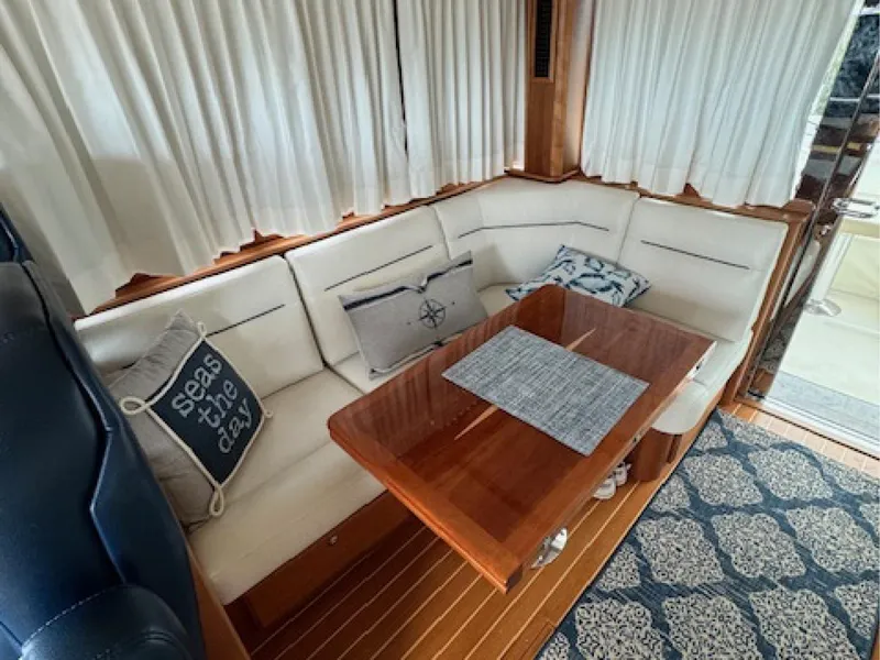 Slide: The Image of Interior of 2017 Sabre 45 Salon Express with cozy seating and nautical decor. - 8