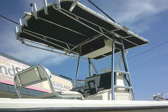Slide: The Image of 2002 Parker 2501 Center Console boat with T-top under clear blue sky. - 11