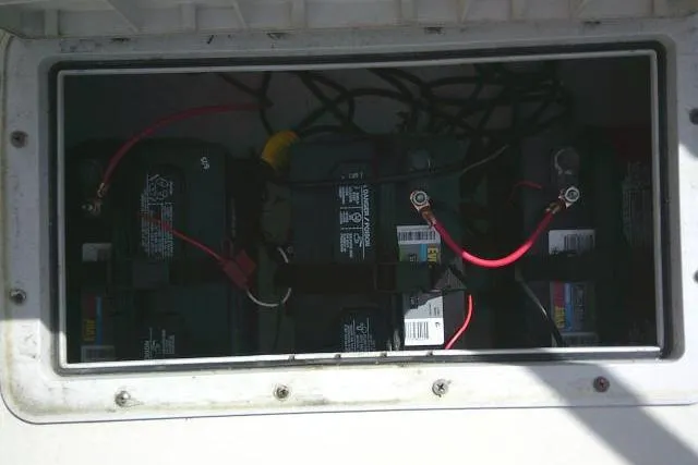 Slide: The Image of Battery compartment of a 2002 Parker 2501 Center Console boat with multiple batteries. - 17