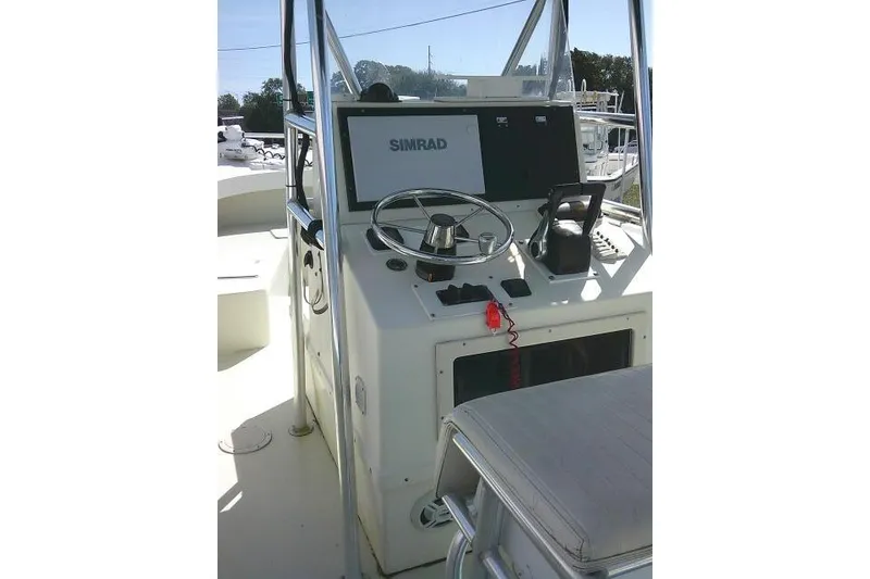 Slide: The Image of 2002 Parker 2501 Center Console boat helm with Simrad navigation system. - 24
