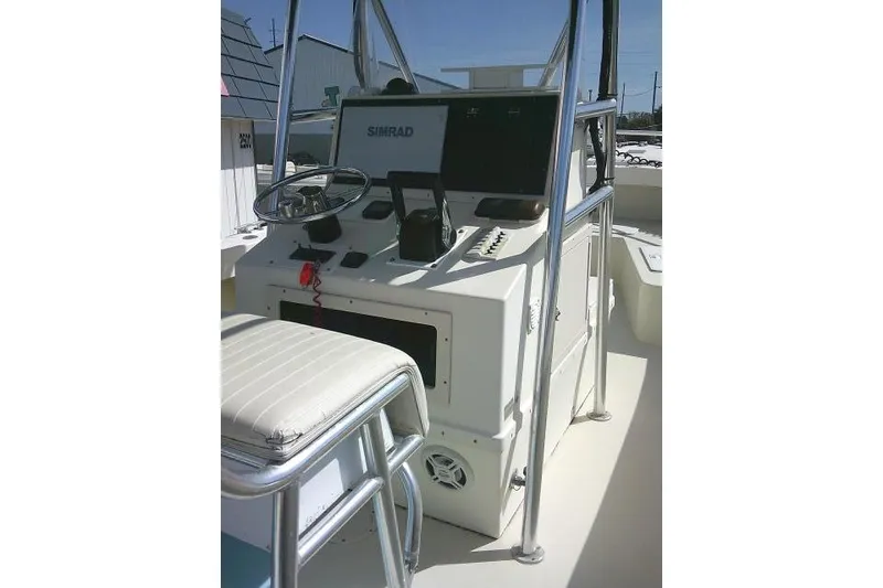 Slide: The Image of 2002 Parker 2501 Center Console boat interior with steering wheel and Simrad electronics. - 25