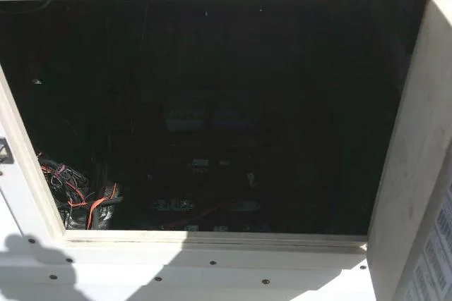 Slide: The Image of Dark interior of 2002 Parker 2501 Center Console boat with visible wiring. - 26