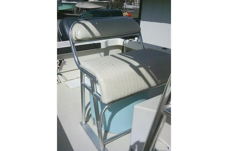 Slide: The Image of Parker 2501 Center Console 2002 boat seat with metal frame and cushioned backrest. - 28