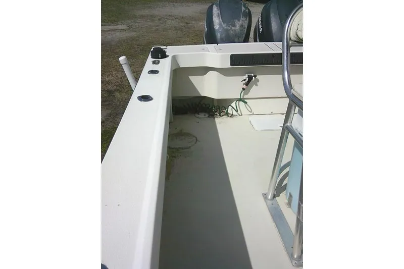 Slide: The Image of 2002 Parker 2501 Center Console boat interior with dual engines and clean deck. - 29