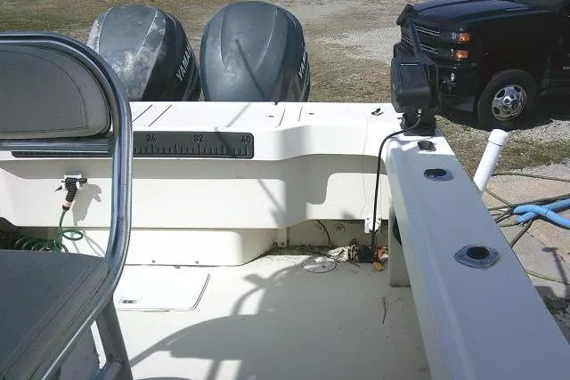 Slide: The Image of 2002 Parker 2501 Center Console boat with dual Yamaha engines and a truck in the background. - 31
