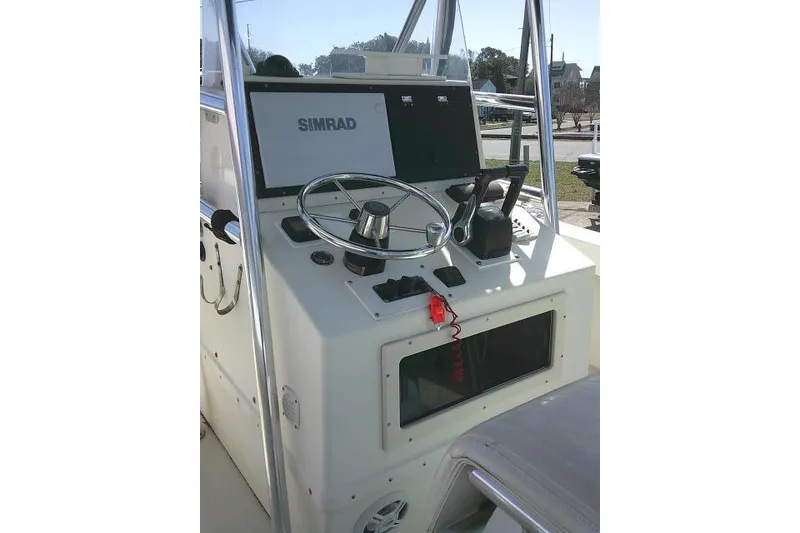 Slide: The Image of 2002 Parker 2501 Center Console boat helm with Simrad navigation system. - 32
