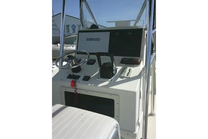 Slide: The Image of 2002 Parker 2501 Center Console boat dashboard with Simrad navigation system. - 39