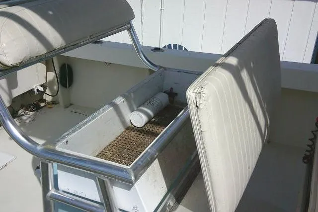 Slide: The Image of Open storage compartment on 2002 Parker 2501 Center Console boat with white seating. - 41