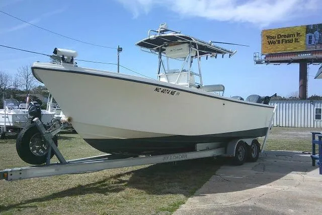 Slide: The Image of 2002 Parker 2501 Center Console boat on trailer, parked outdoors under clear sky. - 5