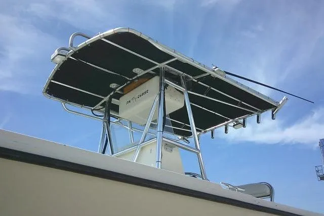 Slide: The Image of 2002 Parker 2501 Center Console boat with T-top against blue sky. - 6