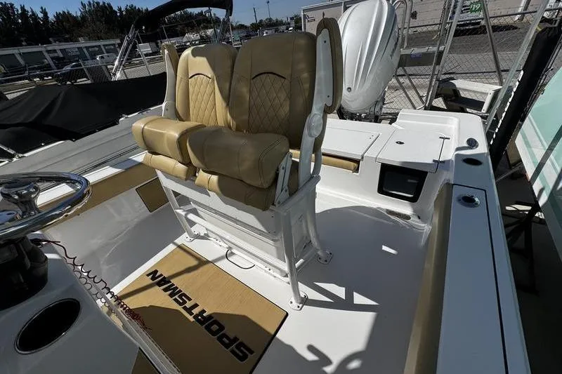 Slide: The Image of 2026 Sportsman Masters 247 Bay Boat interior with tan seating and steering console. - 11