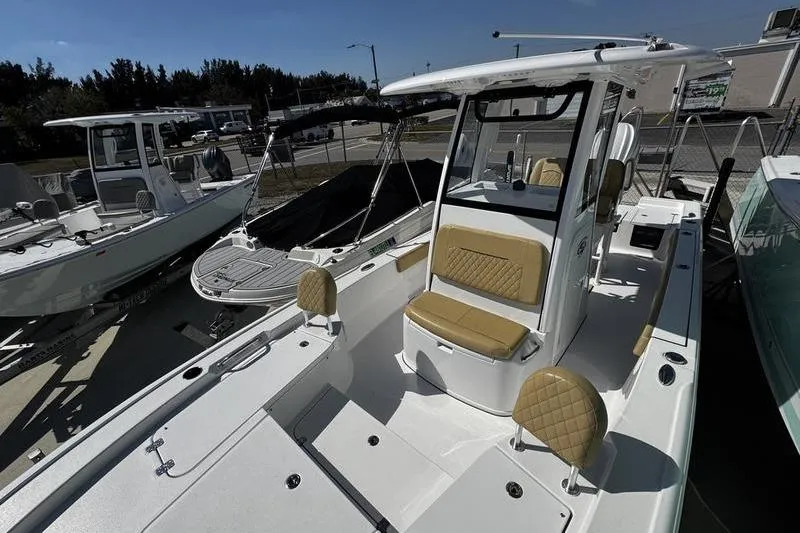 Slide: The Image of 2026 Sportsman Masters 247 Bay Boat with tan seating, docked outdoors. - 12