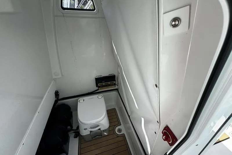Slide: The Image of Interior of 2026 Sportsman Masters 247 Bay Boat with compact marine toilet. - 16