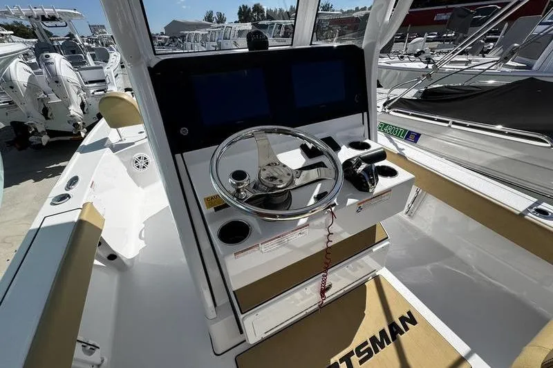 Slide: The Image of 2026 Sportsman Masters 247 Bay Boat cockpit with steering wheel and dual displays. - 18