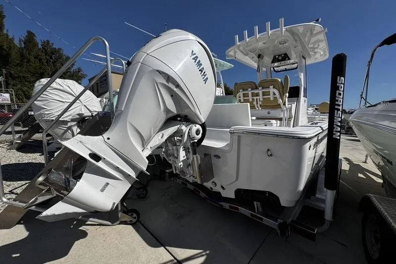 Slide: The Image of 2026 Sportsman Masters 247 Bay Boat with Yamaha engine, docked outdoors. - 2
