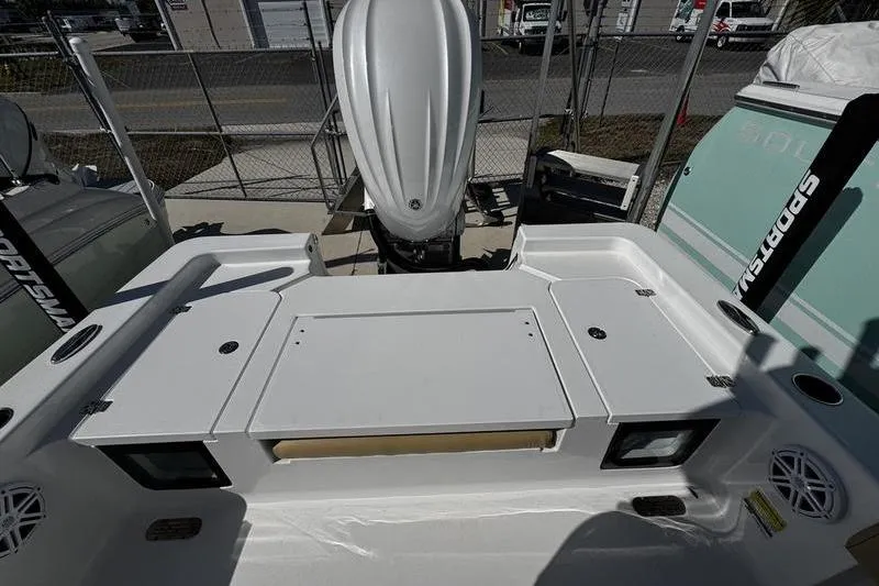 Slide: The Image of 2026 Sportsman Masters 247 Bay Boat, rear deck view with engine and storage compartments. - 22