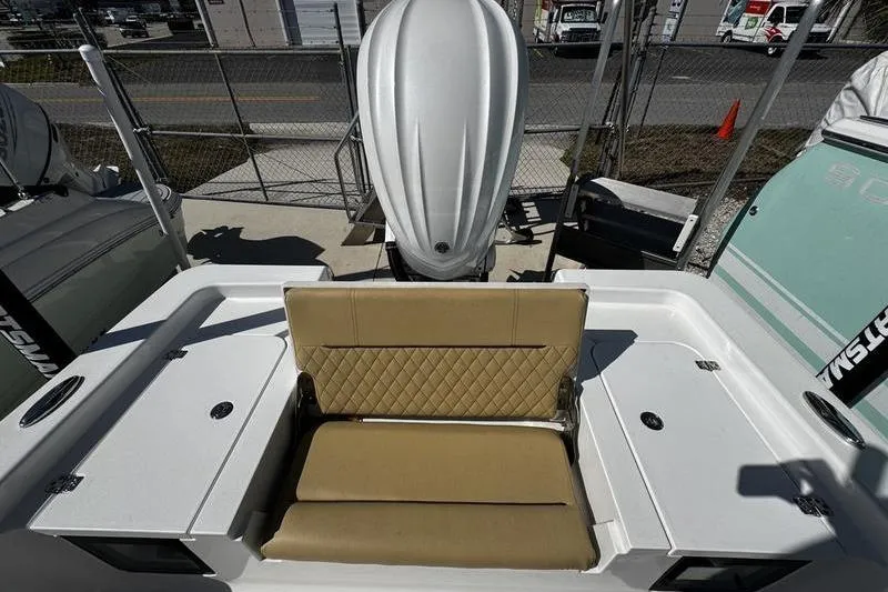 Slide: The Image of 2026 Sportsman Masters 247 Bay Boat with tan seating and outboard motor. - 23