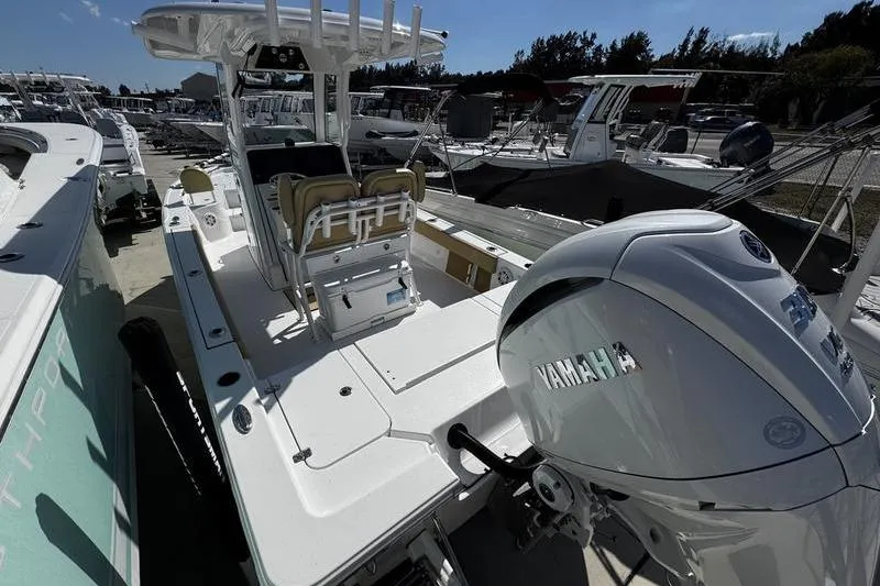 Slide: The Image of 2026 Sportsman Masters 247 Bay Boat with Yamaha engine, docked among other boats. - 25