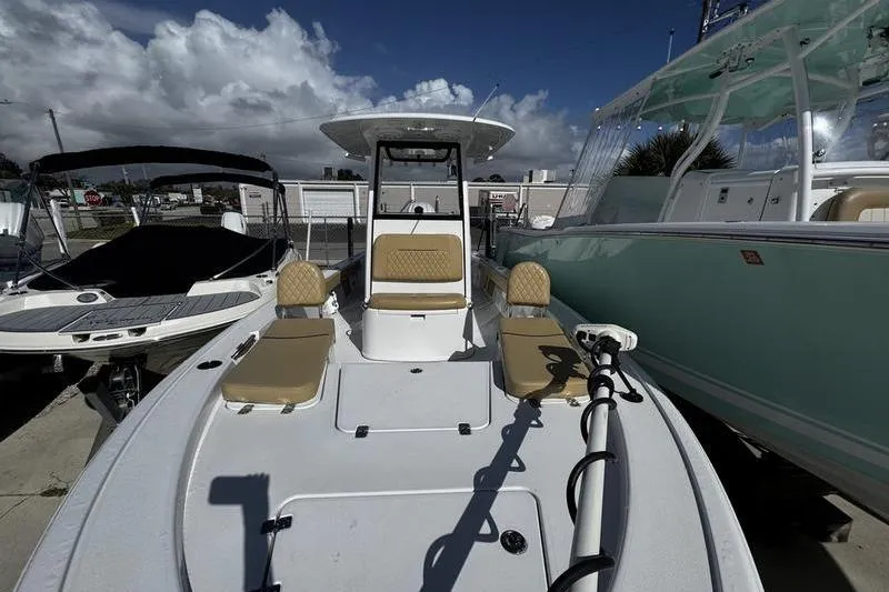 Slide: The Image of 2026 Sportsman Masters 247 Bay Boat with seating, docked under a cloudy sky. - 4
