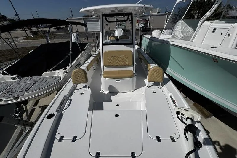 Slide: The Image of 2026 Sportsman Masters 247 Bay Boat with spacious deck and seating, docked outdoors. - 7