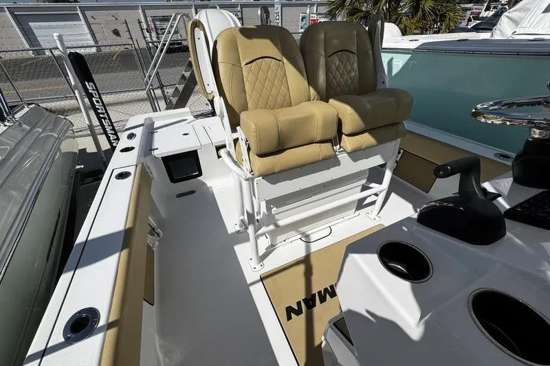 Slide: The Image of 2026 Sportsman Masters 247 Bay Boat interior with tan seats and console. - 9