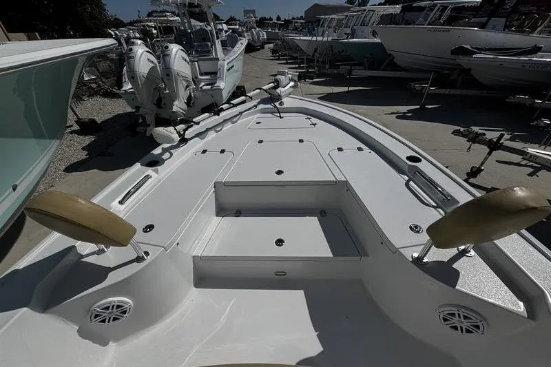 Slide: The Image of 2026 Sportsman Masters 247 Bay Boat, spacious deck view at a marina. - 5