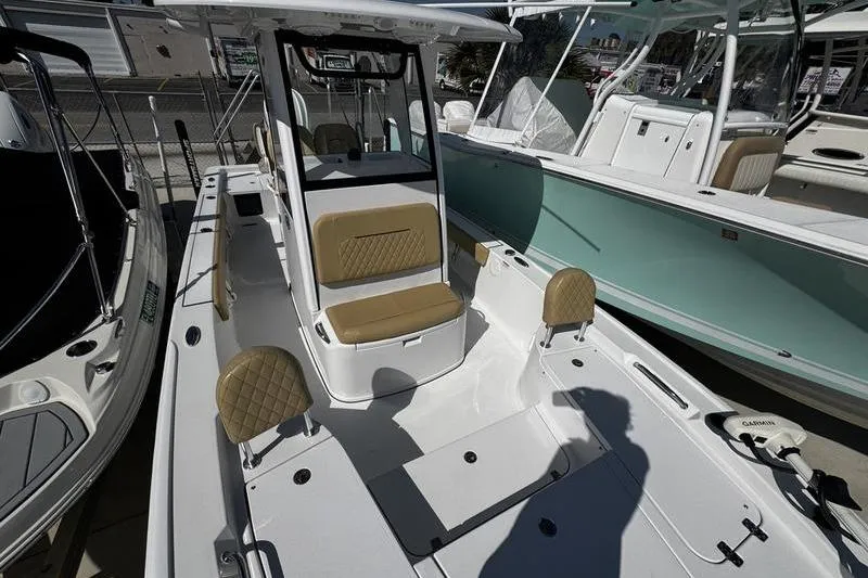 Slide: The Image of 2026 Sportsman Masters 247 Bay Boat with tan seating and sleek design. - 6