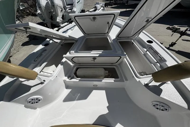 Slide: The Image of 2026 Sportsman Masters 247 Bay Boat with open storage compartments and seating. - 8