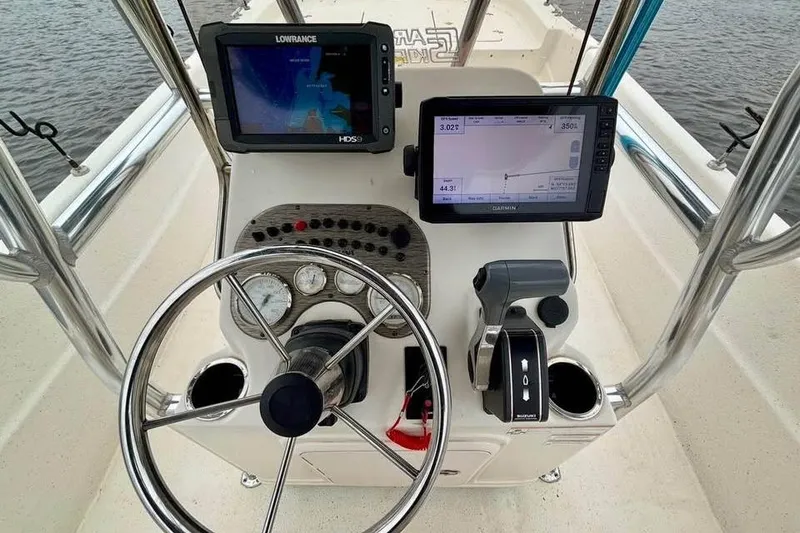 Slide: The Image of 2017 Carolina Skiff 238 DLV boat console with navigation screens and steering wheel. - 7